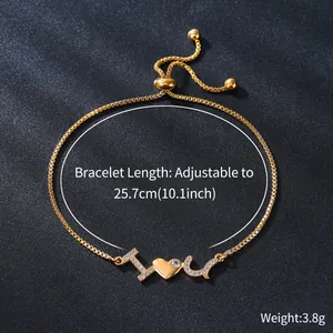 Detail view of gold-plated I Love U bracelet with zircon accents on black background