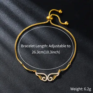 Detailed view of gold-plated adjustable bracelet with sparkling zircon angel wing charm