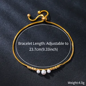 Close-up of gold copper bracelet featuring three pearls and adjustable sliding clasp