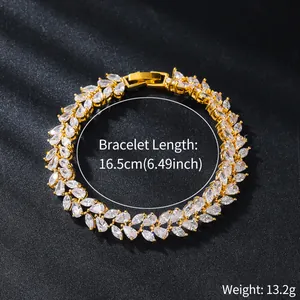 Detailed macro view of a gold leaf-shaped zircon bracelet showing size and weight.
