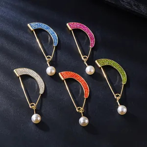 Detailed view of colorful rhinestone arc brooches with pearls in five vibrant color options.
