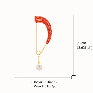 Detailed view of curved red rhinestone brooch pin with pearl dangle and dimensions.