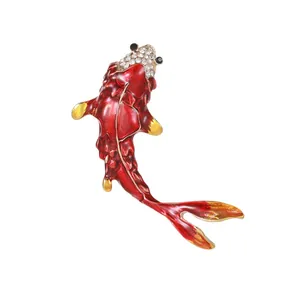 Elegant red enamel koi fish brooch with crystal embellishments on white background