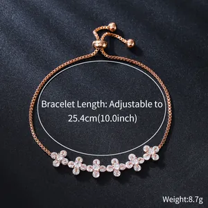 Close-up of adjustable rose gold bracelet with flower-shaped cubic zirconia stones.