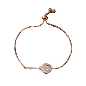 Rose gold zircon bracelet featuring unique key and smiley face charms with sliding clasp.
