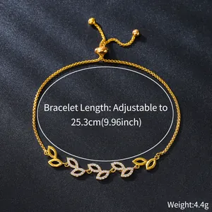 Detailed view of the gold-plated leaf bracelet featuring cubic zirconia inlay and specs