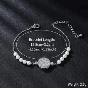 Detailed close-up of elegant pearl and zircon paved disc bracelet on dark background