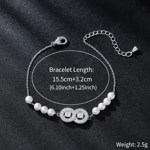 Close-up view of an elegant zircon infinity bracelet with pearls and adjustable chain