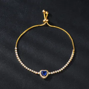 Adjustable gold-plated tennis bracelet featuring a blue heart-shaped cubic zirconia.