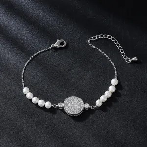 Elegant silver-toned zircon and pearl bracelet with adjustable chain on dark background