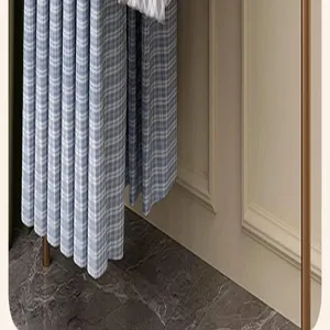 Close-up view of a blue and white plaid skirt hanging neatly on a professional pants hanger