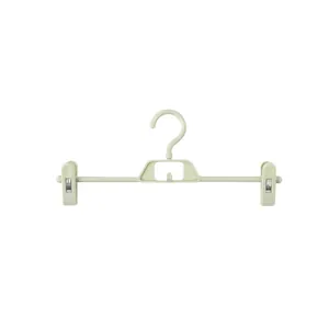 Light green non-marking plastic pants hanger with two clips for trousers and skirts