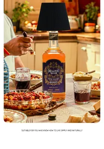 Black pleated LED bottle lamp head used on a whiskey bottle during a cozy dinner party scenario
