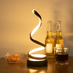 Modern minimalist spiral LED rechargeable table lamp with warm light for bar decor.