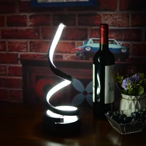 Modern spiral LED rechargeable table lamp creating a cozy atmosphere for bars and clubs