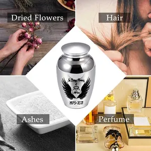 Small silver memorial cremation urn for ashes with engraved heart and wings design