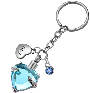 Vue détaillée d'un porte-clés urne en cristal bleu en forme de cœur en acier inoxydable.