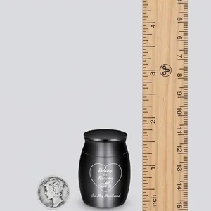 Black stainless steel memorial urn 30mm x 40mm with ruler and coin for size scale comparison