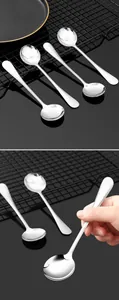 Exquisite polished stainless steel long handle spoon shown in a hand for scale and detail