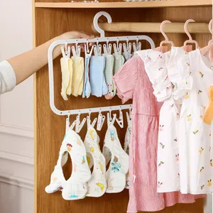 White multi-clip baby clothes drying rack for hanging socks and bibs in a wardrobe