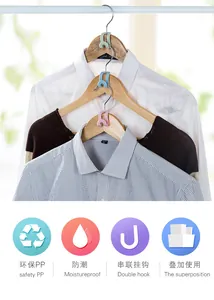 Detailed view of colorful space-saving clothes hanger connector hooks in closet