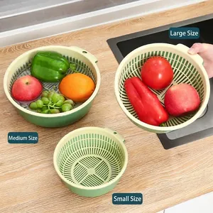 Set of 3 double-layer green and cream kitchen drain baskets for washing vegetables.
