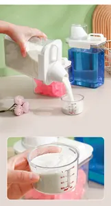 Close-up view of laundry powder storage container featuring a clear 150ml measuring cup