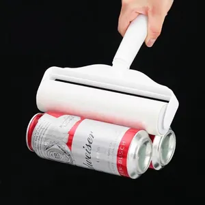 Portable lint roller with high-tack adhesive shown lifting cans for strength test.