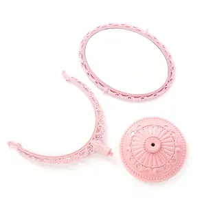 Miroir de maquillage vintage rose avec design double face et base à fleurs élégante