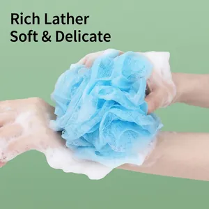 Large light blue shower loofah ball with rich white foam for deep skin exfoliation