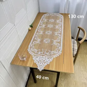 Detailed view of white embroidered table runner with 130x40cm dimension markings.