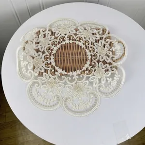 Detail of 42cm round lace placemat with elegant floral embroidery