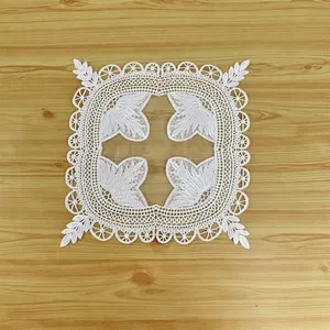 Detailed view of the vintage white lace embroidered coaster with intricate leaf patterns