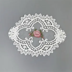 Detailed close-up of a pink rose floral embroidery on white hollow mesh lace patch