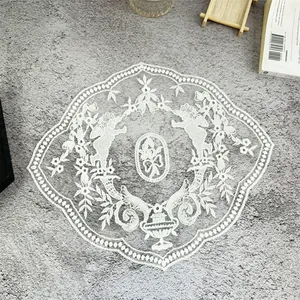 Vintage white lace embroidered placemat featuring angel and floral patterns on mesh fabric