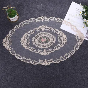 Detailed look at the oval French lace table runner with intricate floral embroidery