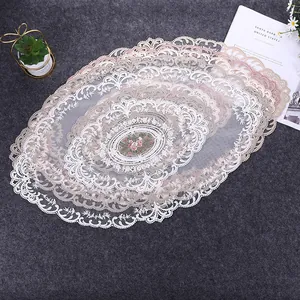 Detailed macro shot of vintage French style oval lace doily with elegant floral embroidery