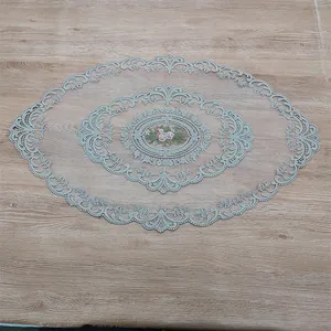 Detailed view of an oval French lace tablecloth with elegant pink floral embroidery