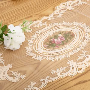 Close-up detail of an elegant European lace mesh table runner with floral embroidery