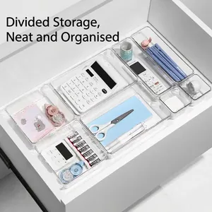 Clear plastic drawer organizer bins for office stationery and desk organization.