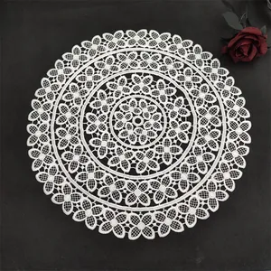 Intricate white lace circular placemat detail showing delicate floral crochet pattern