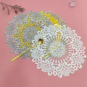 Close-up of elegant embroidered lace round coasters in white, silver, and yellow colors