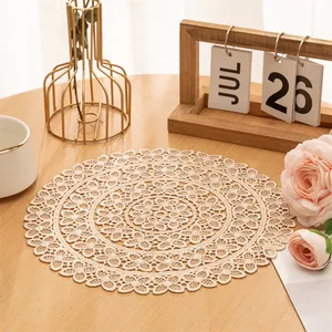 Detailed view of intricate cream lace woven placemat decoration on a wooden table