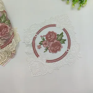 Detailed view of embroidered rose lace coaster with elegant hollow design for home decor.