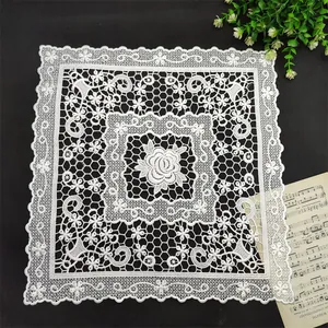 Detailed view of white square lace placemat featuring elegant floral rose embroidery.