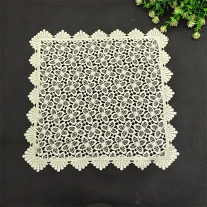 Detailed view of a square cream lace mat featuring intricate floral embroidery and scalloped edges.
