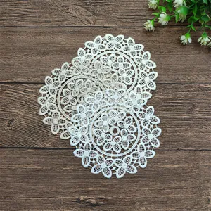 Detailed close-up showing three delicate round lace coasters with floral embroidery
