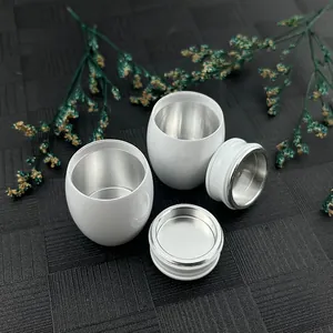 Close-up detail of small white metal cremation urns for human or pet ashes storage