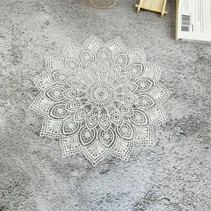 Detailed view of intricate white lace doily with vintage French floral embroidery pattern