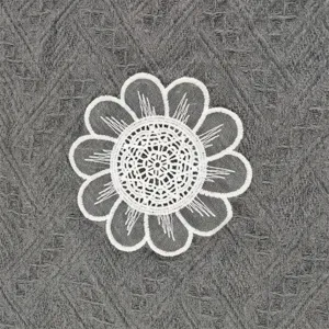 Close-up of white embroidered lace flower coaster patch